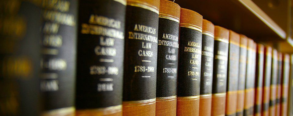 Antique law books on wooden shelf
